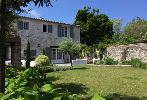 Stone house next to the shops having a beautiful garden