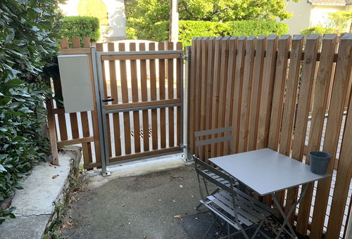 Wohnzimmer mit Zugang zu einer kleinen Außenterrasse.