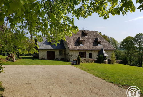 The house consists of a living room with a wood stove and television,...