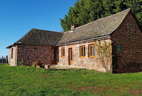 Detached single-storey red sandstone house located on an enclosed plot of...